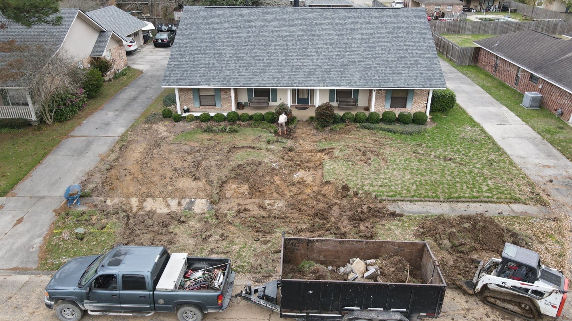 Aerial view of a brick ranch with its old lawn removed